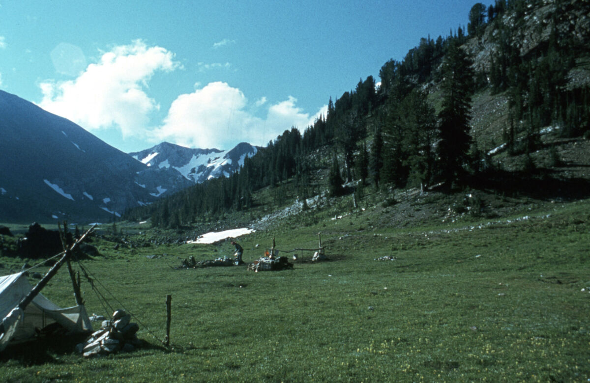 W. “Bill” George tends the fire at a backcountry camp. Taken by Janie Tippett.