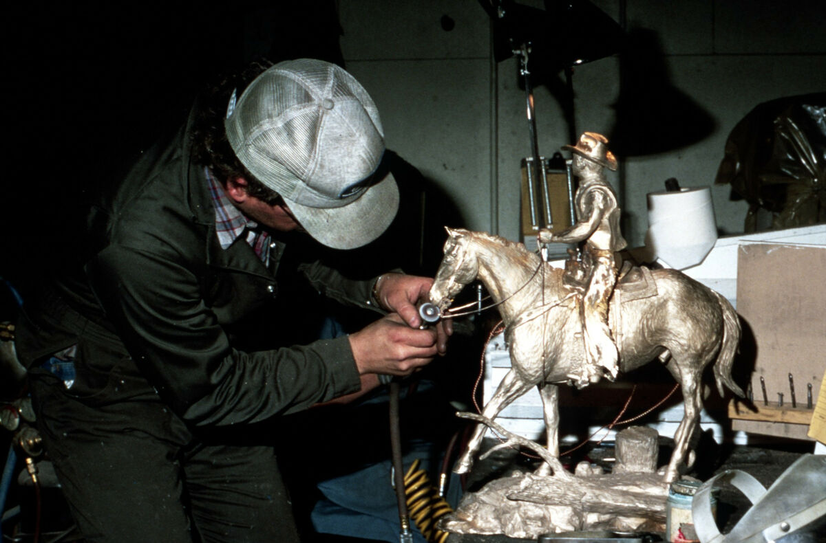 Putting the finishing touches on a bronze statue at the Valley Bronze foundry. Taken by Steve Roundy.